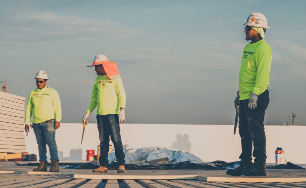King of Texas crew standing by on a commercial roof during repair and maintenance operations.