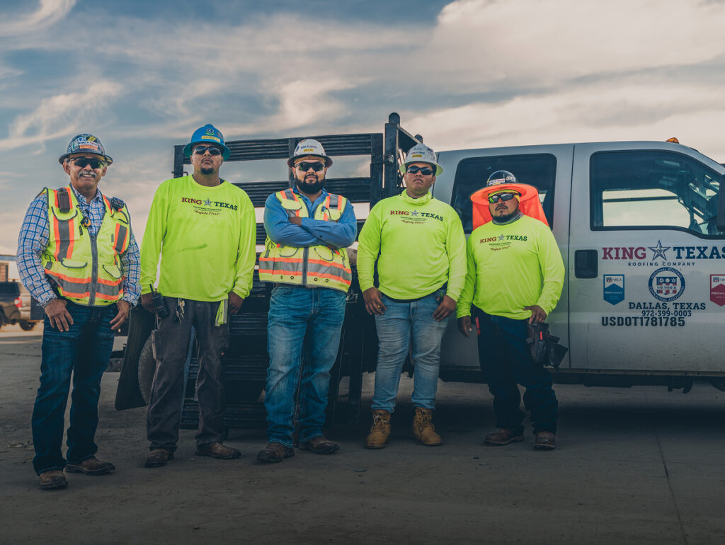 King of Texas construction crew standing together at a job site in safety gear