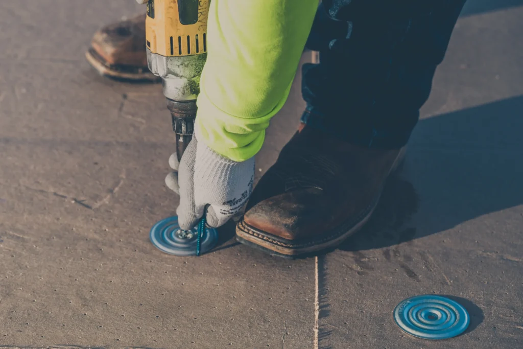 King of Texas commercial roofing contractor securing a commercial roofing system